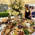 Elegant event buffet table with gourmet food and floral decor by Rivera Events in Miami